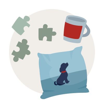 Vankúš s motívom psa, puzzle kúsky a hrnček na svetlom pozadí
