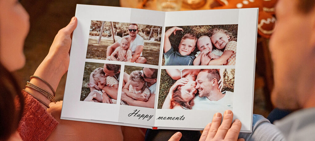 Dve osoby listujú fotoalbumom s krásnymi rodinnými momentmi.
