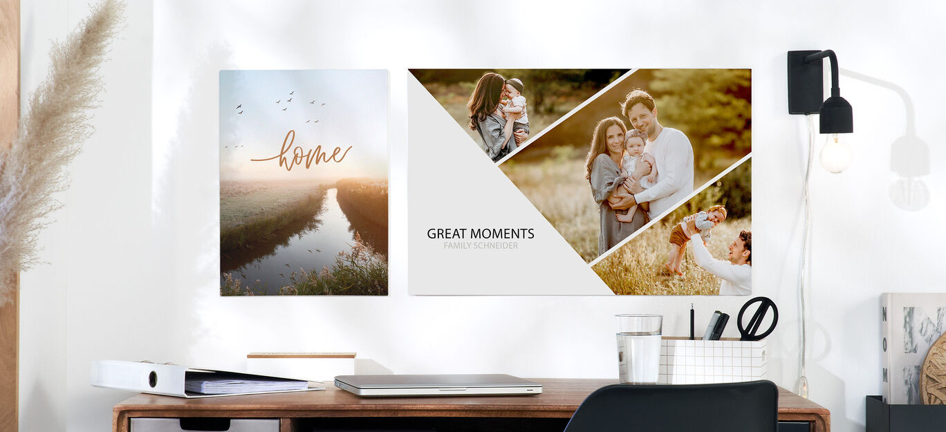 Nástenné obrazy s nápisom 'home' a 'great moments' nad stolom.